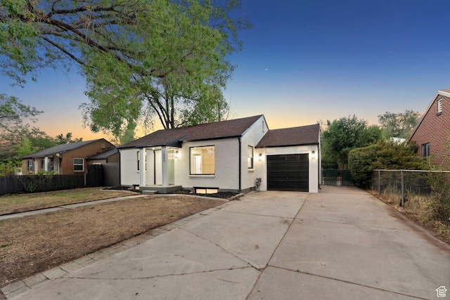 1043 S 1300 W, Salt Lake City, UT 84104 - view of front facade featuring concrete driveway, a garage, and roof with shingles