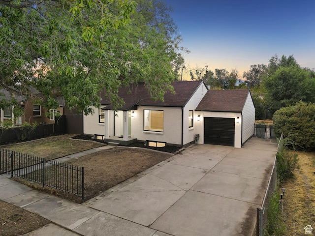 1043 S 1300 W, Salt Lake City, UT 84104 - view of front of property with an attached garage, driveway, a fenced front yard, and a shingled roof