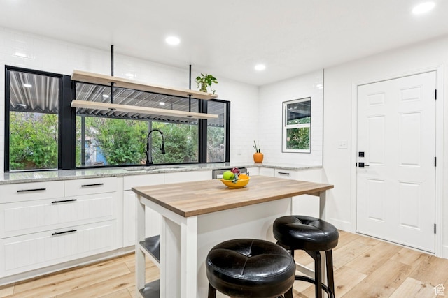1043 S 1300 W, Salt Lake City, UT 84104 - kitchen with wood counters, light wood-type flooring, white cabinetry, healthy amount of natural light, and recessed lighting