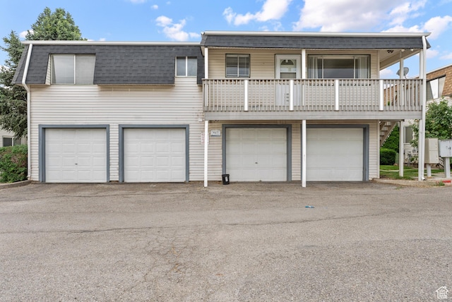 1191 W 4300 S Unit 15A, Taylorsville, UT 84123 - view of front of property with an attached garage, mansard roof, a shingled roof, and driveway