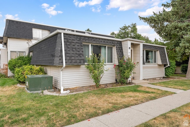 1191 W 4300 S Unit 15A, Taylorsville, UT 84123 - view of home's exterior featuring a shingled roof, mansard roof, and a yard