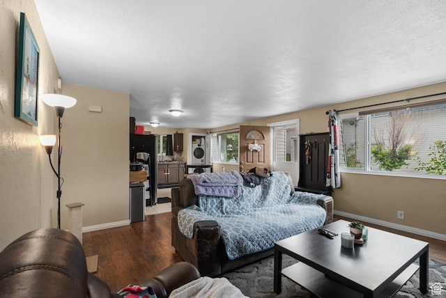 1191 W 4300 S Unit 15A, Taylorsville, UT 84123 - living area featuring dark wood finished floors and stacked washer / drying machine