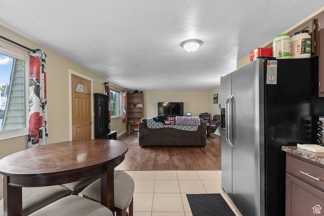 1191 W 4300 S Unit 15A, Taylorsville, UT 84123 - living room with healthy amount of natural light, light tile patterned floors, and a textured ceiling