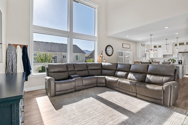 4982 N Goosefoot Dr Unit 51, Eagle Mountain, UT 84005 - living room with wood finished floors, recessed lighting, and a towering ceiling
