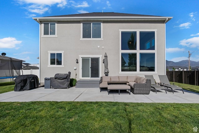 4982 N Goosefoot Dr Unit 51, Eagle Mountain, UT 84005 - back of house featuring a trampoline, a patio area, and stucco siding