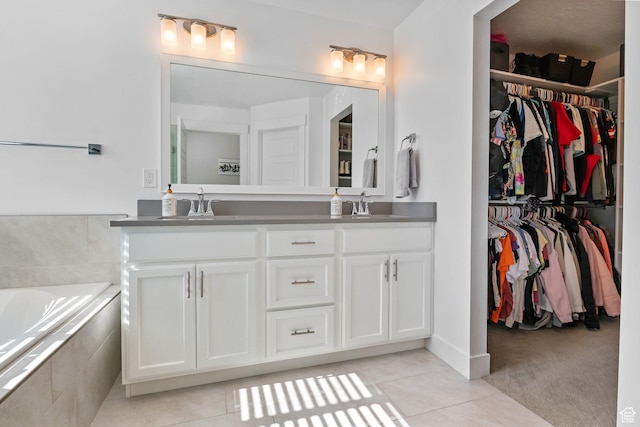 4982 N Goosefoot Dr Unit 51, Eagle Mountain, UT 84005 - bathroom featuring double vanity, tile patterned flooring, a bath, and a walk in closet