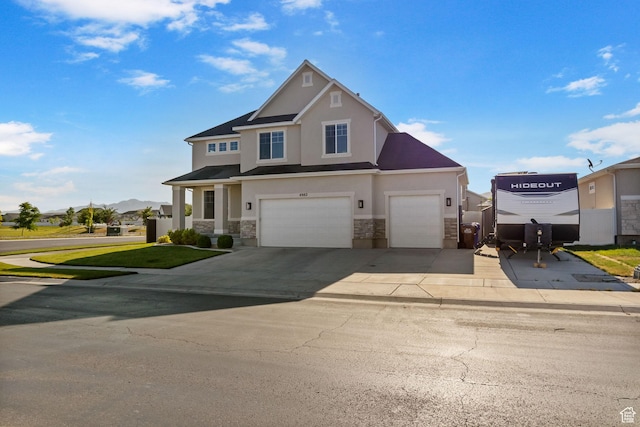 4982 N Goosefoot Dr Unit 51, Eagle Mountain, UT 84005 - view of front of house with stone siding, stucco siding, driveway, and an attached garage