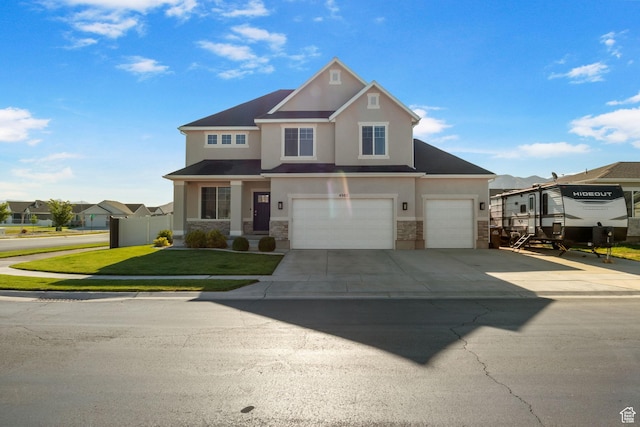 4982 N Goosefoot Dr Unit 51, Eagle Mountain, UT 84005 - view of front of house featuring stone siding, stucco siding, driveway, an attached garage, and a residential view