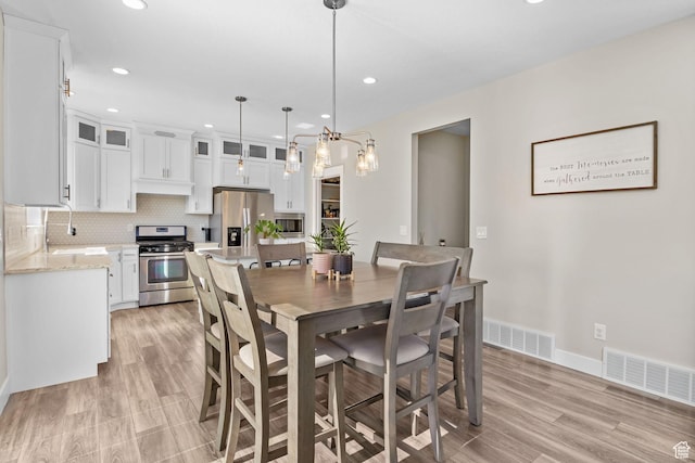 4982 N Goosefoot Dr Unit 51, Eagle Mountain, UT 84005 - dining area with recessed lighting, light wood-style floors, and a chandelier