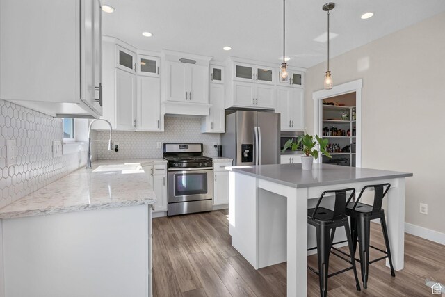 4982 N Goosefoot Dr Unit 51, Eagle Mountain, UT 84005 - kitchen with appliances with stainless steel finishes, tasteful backsplash, white cabinetry, light wood-style flooring, and recessed lighting