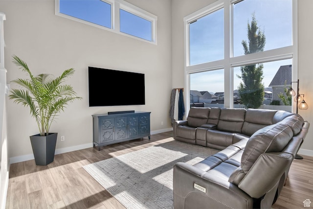 4982 N Goosefoot Dr Unit 51, Eagle Mountain, UT 84005 - living area featuring a towering ceiling and wood finished floors