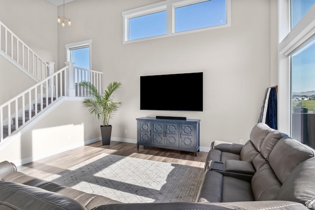 4982 N Goosefoot Dr Unit 51, Eagle Mountain, UT 84005 - living room with stairs, wood finished floors, and a towering ceiling