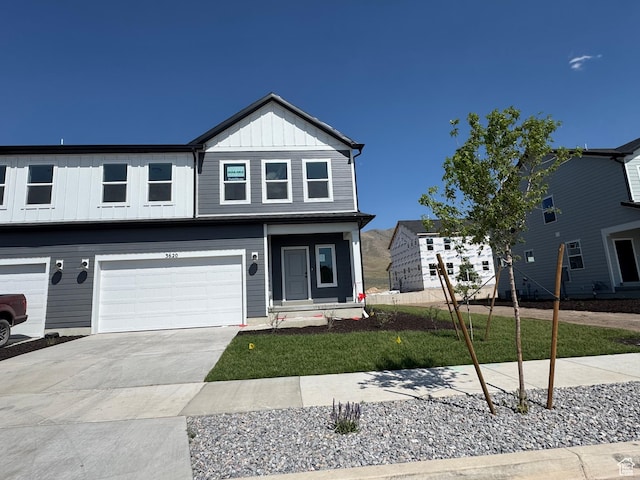 3620 N Stallion St Unit 349, Eagle Mountain, UT 84005 - view of front facade with board and batten siding, driveway, and an attached garage