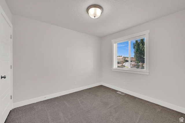 2782 W 4140 S Unit 246, Roy, UT 84067 - spare room with dark carpet and a textured ceiling