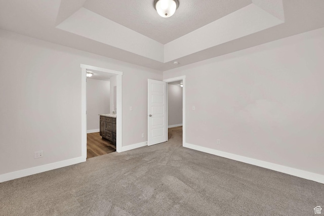 2782 W 4140 S Unit 246, Roy, UT 84067 - spare room featuring a raised ceiling, carpet flooring, and a textured ceiling