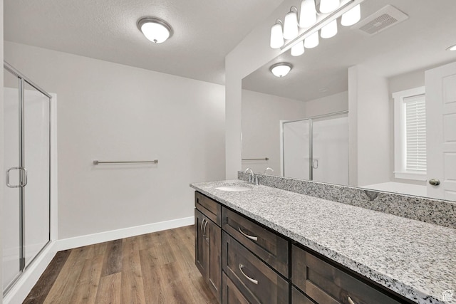 2782 W 4140 S Unit 246, Roy, UT 84067 - bathroom featuring wood finished floors, a shower stall, and vanity