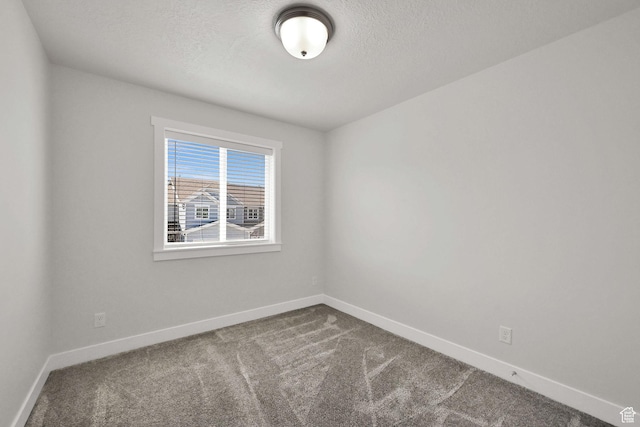2782 W 4140 S Unit 246, Roy, UT 84067 - unfurnished room with dark carpet and a textured ceiling