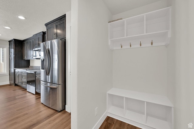 2782 W 4140 S Unit 246, Roy, UT 84067 - mudroom featuring light wood finished floors, recessed lighting, and a textured ceiling