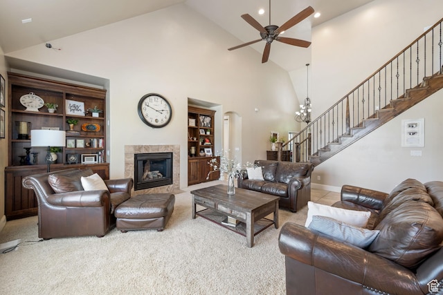 358 S 1040 W, Hurricane, UT 84737 - carpeted living room featuring high vaulted ceiling, stairway, a ceiling fan, a fireplace, and arched walkways