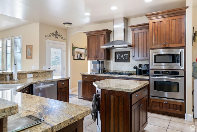 358 S 1040 W, Hurricane, UT 84737 - kitchen featuring appliances with stainless steel finishes, wall chimney range hood, light tile patterned floors, a center island, and recessed lighting