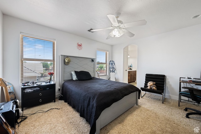 358 S 1040 W, Hurricane, UT 84737 - bedroom with light colored carpet, arched walkways, ceiling fan, a desk, and ensuite bathroom