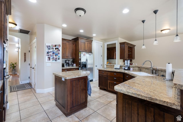 358 S 1040 W, Hurricane, UT 84737 - kitchen with stainless steel fridge with ice dispenser, a peninsula, pendant lighting, light tile patterned floors, and light stone counters