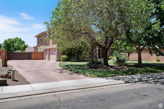 358 S 1040 W, Hurricane, UT 84737 - obstructed view of property featuring concrete driveway, stucco siding, a gate, and a garage