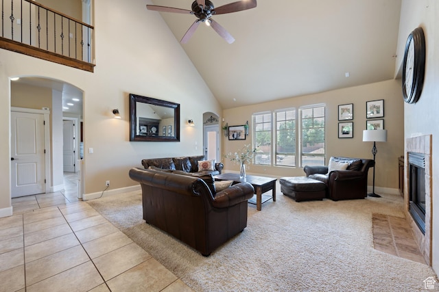358 S 1040 W, Hurricane, UT 84737 - carpeted living area featuring high vaulted ceiling, arched walkways, ceiling fan, a tiled fireplace, and tile patterned flooring