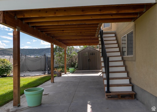 4636 E Ponderosa Way, Eagle Mountain, UT 84005 - view of patio with a storage shed, stairs, and a trampoline