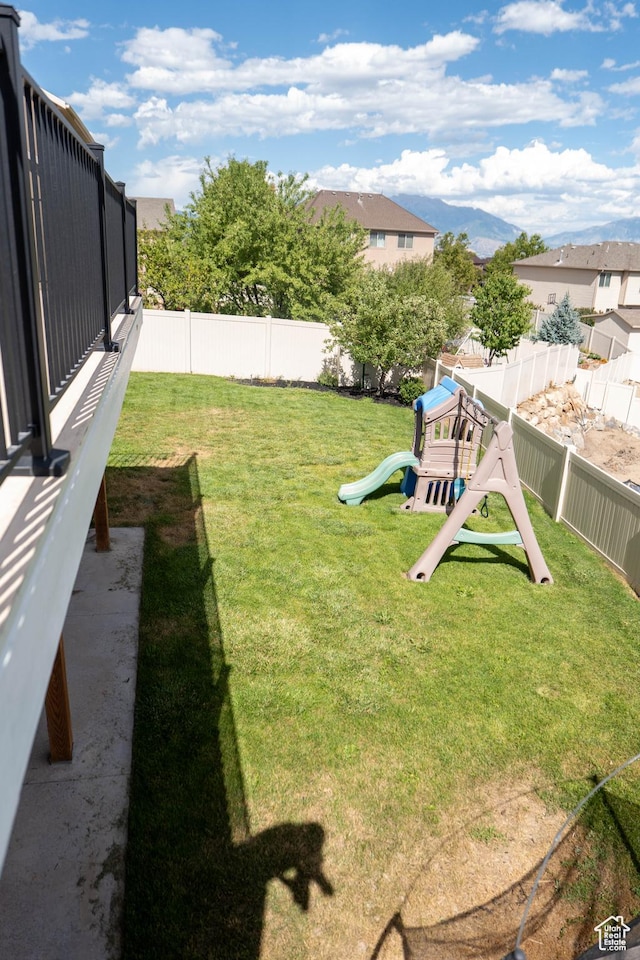 4636 E Ponderosa Way, Eagle Mountain, UT 84005 - fenced backyard with a playground and a mountain view