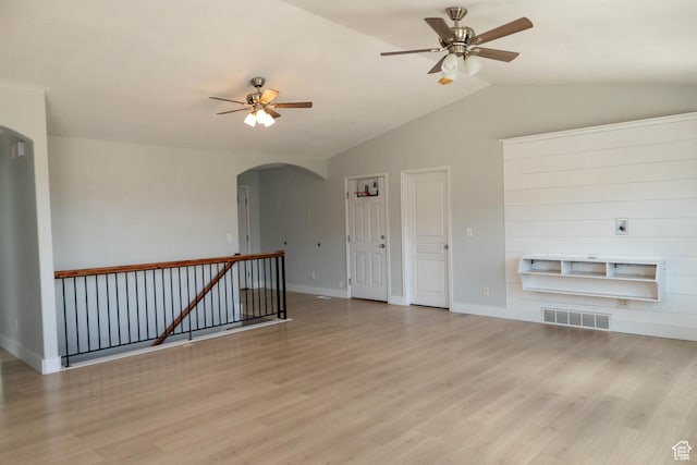 4636 E Ponderosa Way, Eagle Mountain, UT 84005 - unfurnished living room with arched walkways, a ceiling fan, vaulted ceiling, and light wood-type flooring