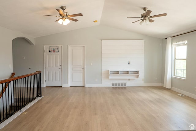 4636 E Ponderosa Way, Eagle Mountain, UT 84005 - unfurnished living room with ceiling fan, vaulted ceiling, arched walkways, and light wood-style flooring