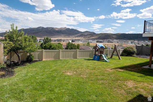 4636 E Ponderosa Way, Eagle Mountain, UT 84005 - fenced backyard featuring a playground and a mountain view