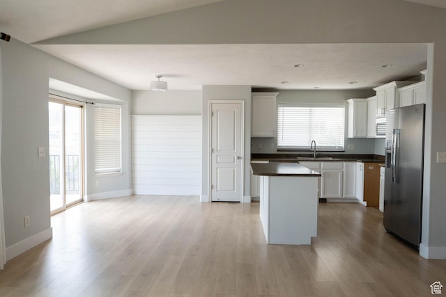 4636 E Ponderosa Way, Eagle Mountain, UT 84005 - kitchen with stainless steel fridge, dark countertops, a kitchen island, white cabinetry, and light wood-type flooring
