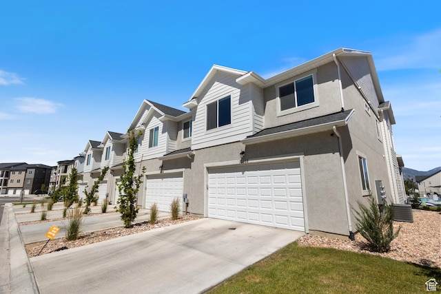 13568 S Vernet Dr W Unit 1824, Riverton, UT 84096 - view of front of home with stucco siding, a residential view, concrete driveway, and a garage