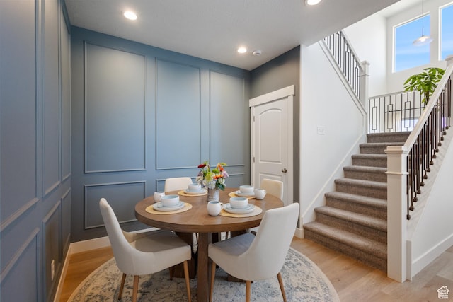 13568 S Vernet Dr W Unit 1824, Riverton, UT 84096 - dining space featuring a decorative wall, stairs, light wood-type flooring, and recessed lighting