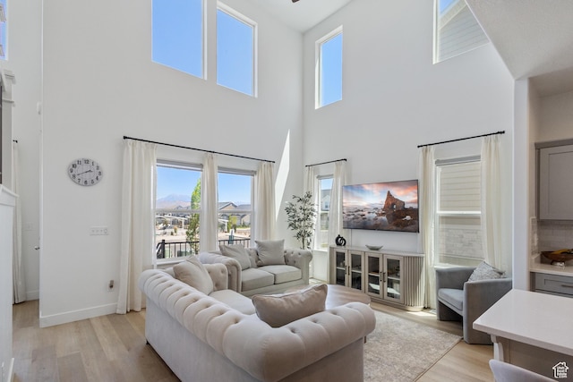 13568 S Vernet Dr W Unit 1824, Riverton, UT 84096 - living area featuring a towering ceiling, light wood finished floors, and plenty of natural light