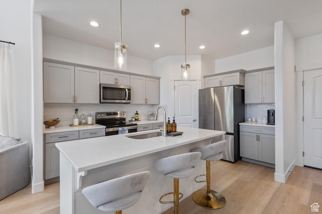 13568 S Vernet Dr W Unit 1824, Riverton, UT 84096 - kitchen featuring appliances with stainless steel finishes, gray cabinets, tasteful backsplash, and recessed lighting
