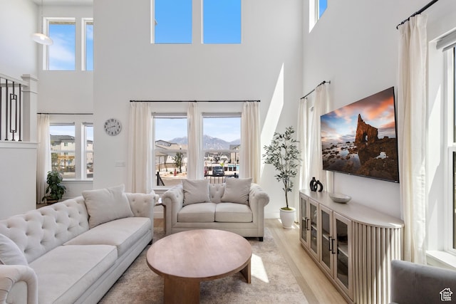 13568 S Vernet Dr W Unit 1824, Riverton, UT 84096 - living room featuring a towering ceiling and light wood-type flooring