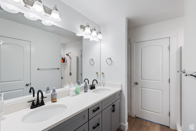 13568 S Vernet Dr W Unit 1824, Riverton, UT 84096 - full bathroom with double vanity, wood finished floors, and a shower with shower door