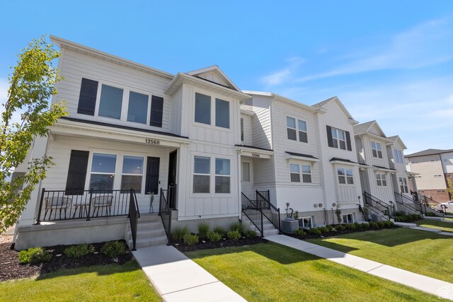 13568 S Vernet Dr W Unit 1824, Riverton, UT 84096 - townhome / multi-family property featuring board and batten siding, a residential view, a front yard, and a porch