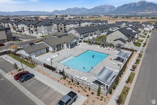 13568 S Vernet Dr W Unit 1824, Riverton, UT 84096 - aerial view of residential area featuring a pool and a mountainous background