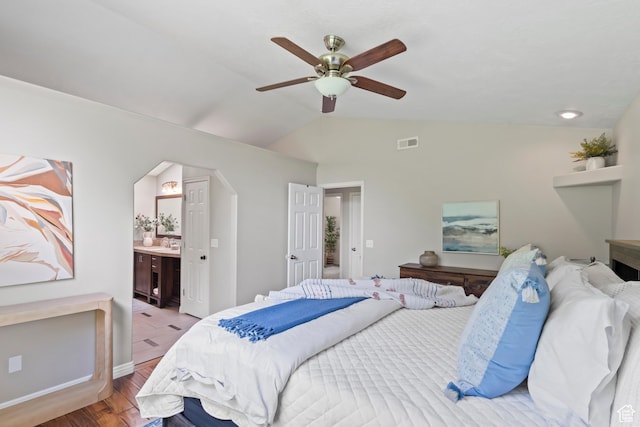 8378 S Sycamore Tree Cv E, Sandy, UT 84094 - bedroom featuring light wood-style floors, vaulted ceiling, arched walkways, ensuite bath, and a ceiling fan