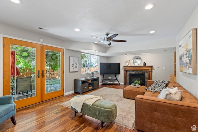 8378 S Sycamore Tree Cv E, Sandy, UT 84094 - living area with wood finished floors, recessed lighting, french doors, a ceiling fan, and a premium fireplace