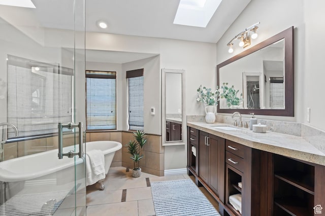 8378 S Sycamore Tree Cv E, Sandy, UT 84094 - bathroom featuring a skylight, vanity, tile patterned flooring, a freestanding bath, and a shower with shower door