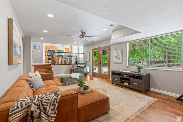 8378 S Sycamore Tree Cv E, Sandy, UT 84094 - living room with wood finished floors, recessed lighting, a ceiling fan, a textured ceiling, and french doors
