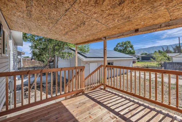 616 N Broadway St, Tooele, UT 84074 - deck featuring an outdoor structure, a mountain view, and a garage