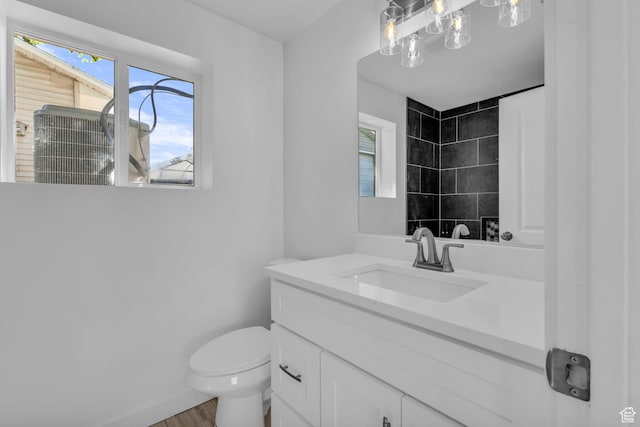 616 N Broadway St, Tooele, UT 84074 - bathroom with vanity, plenty of natural light, a tile shower, and wood finished floors