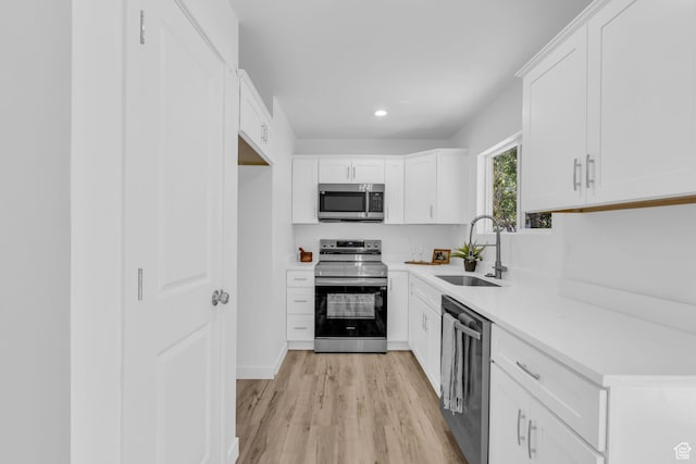616 N Broadway St, Tooele, UT 84074 - kitchen featuring stainless steel appliances, light wood finished floors, light countertops, white cabinets, and recessed lighting