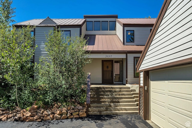 3697 Wagon Wheel Way, Park City, UT 84098 - view of front of property with a garage, a metal roof, and a porch